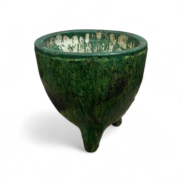 Green ceramic bowl with textured surface on a white background