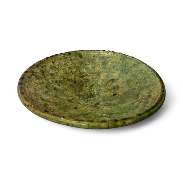 Green ceramic platter on a white background