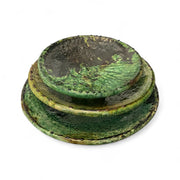 Stack of green ceramic plates on a white background
