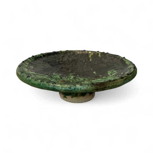 Green ceramic dish on a white background