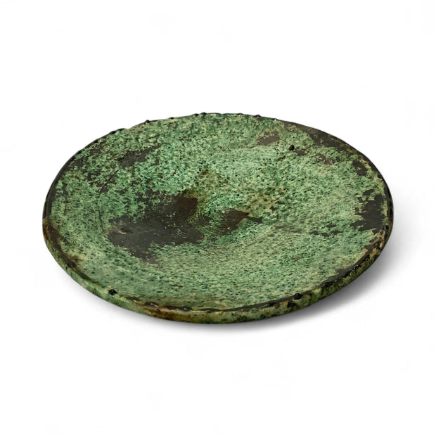 Round greenish plate on a white background