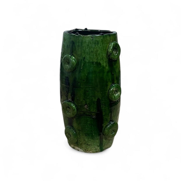 Green ceramic vase with textured surface on a white background