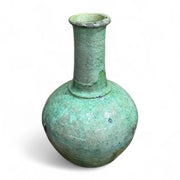 Green glass bottle with a narrow neck on a white background