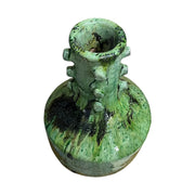 Green ceramic vase with textured surface on a white background