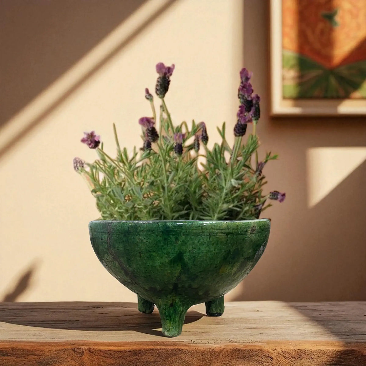 Green Tripod Bowl Planter with lavender plant on a wooden surface