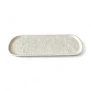 Rectangular ceramic tray with decorative pattern on a white background