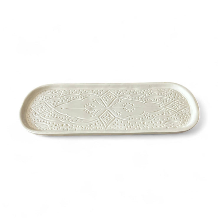 Rectangular ceramic tray with decorative pattern on a white background