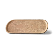 Decorative beige ceramic tray with intricate patterns on a white background