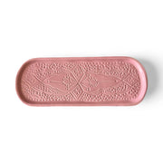 Pink decorative tray with embossed pattern on a white background