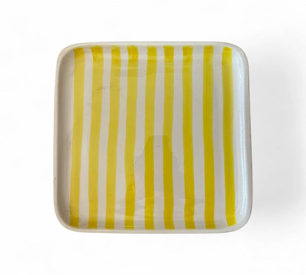 Rectangular ceramic plate with yellow and white vertical stripes on a white background