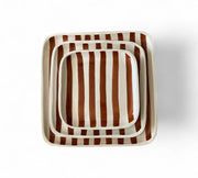 Set of three square ceramic trays with brown and white striped pattern on a white background