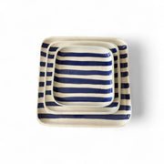 Set of three square ceramic trays with blue and white stripes on a white background