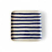 Rectangular ceramic tray with blue and white stripes on a white background