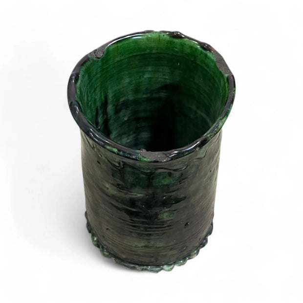 Green ceramic vase on a white background