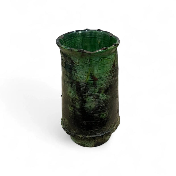 Green ceramic vase with textured surface on a white background