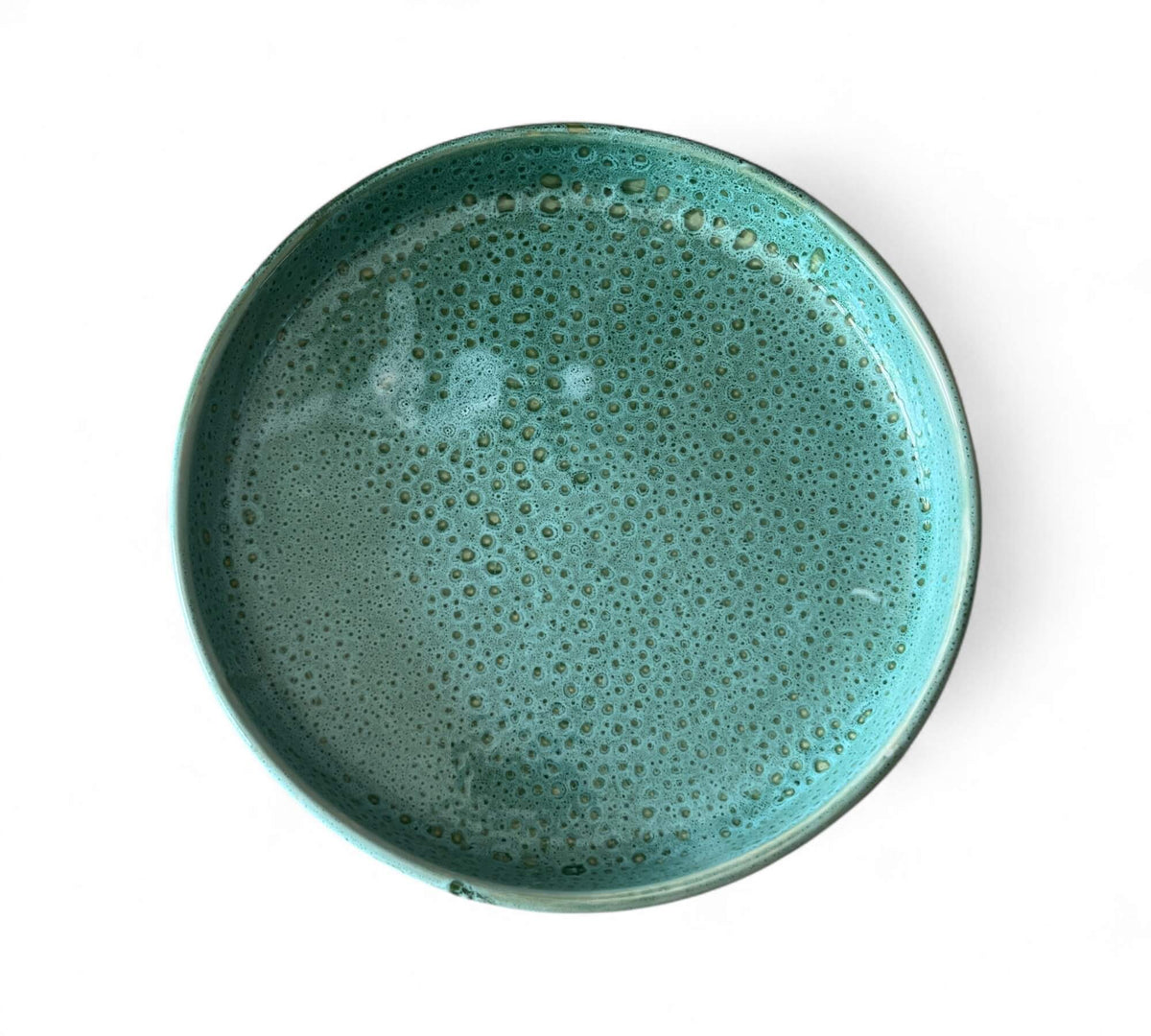 Teal ceramic PLATE with a textured surface on a white background