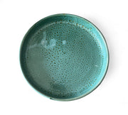 Teal ceramic PLATE with a textured surface on a white background