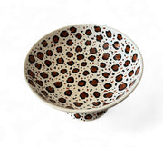 Ceramic bowl with leopard print pattern on a white background