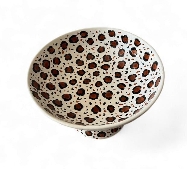 Ceramic bowl with leopard print pattern on a white background