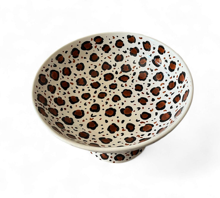 Ceramic bowl with leopard print pattern on a white background