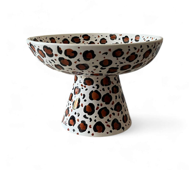 Ceramic bowl with leopard print design on a white background