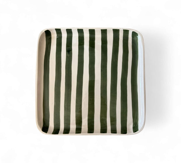 Rectangular ceramic plate with green and white stripes on a white background