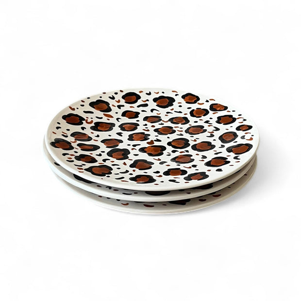 Two ceramic plates with leopard print design on a white background