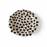 Leopard print ceramic plate on a white background