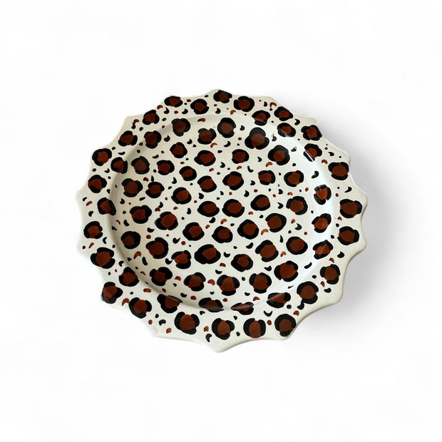Leopard print ceramic plate on a white background