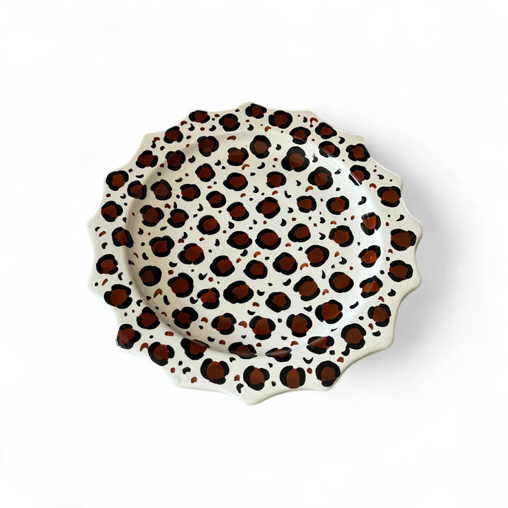 Leopard print ceramic plate on a white background