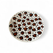 Round plate with leopard print pattern on a white background