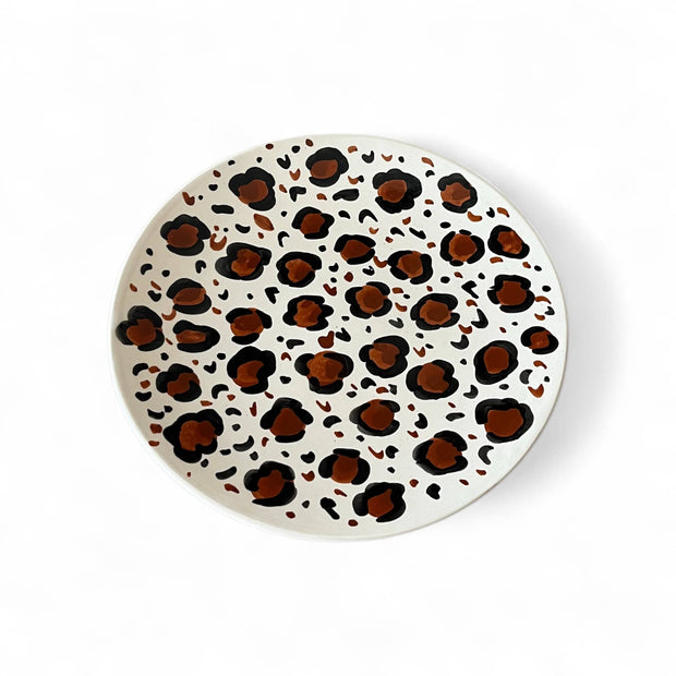 Round plate with leopard print pattern on a white background