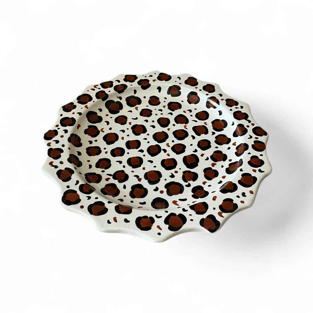 Decorative plate with leopard print pattern on a white background