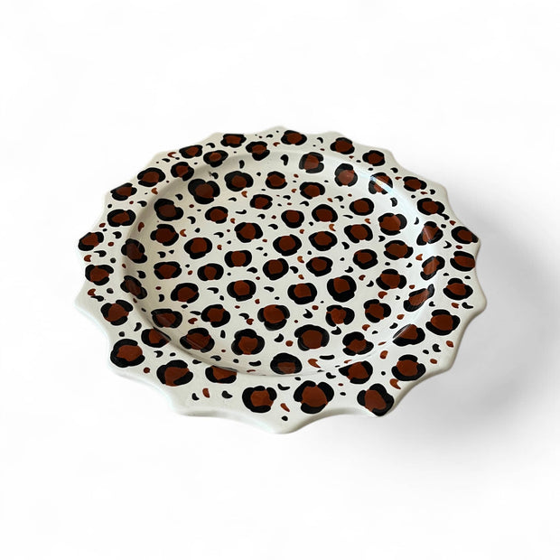 Decorative plate with leopard print pattern on a white background