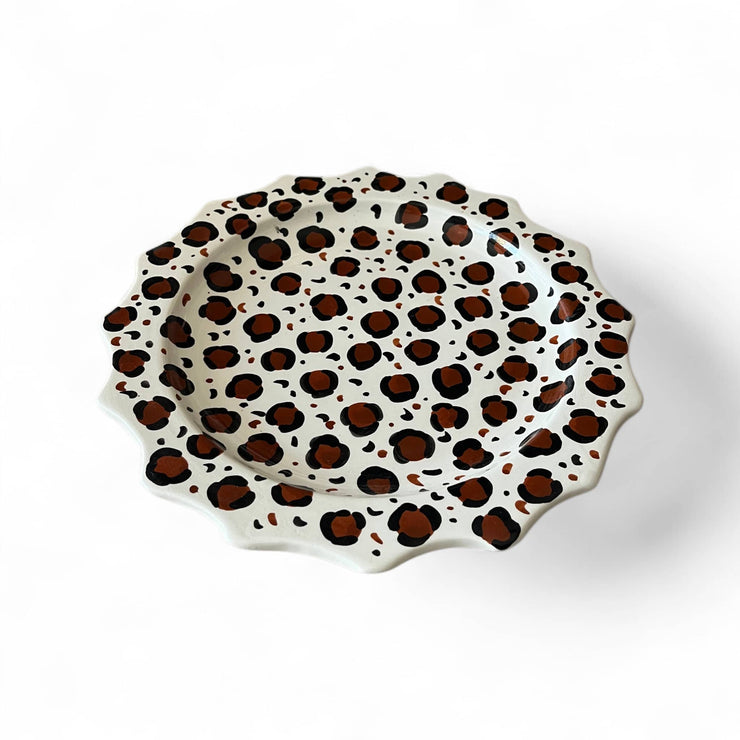 Decorative plate with leopard print pattern on a white background