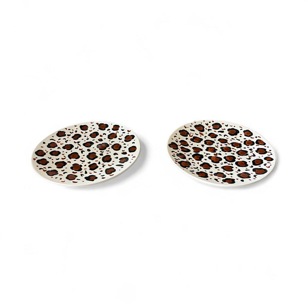 Two ceramic coasters with leopard print pattern on a white background