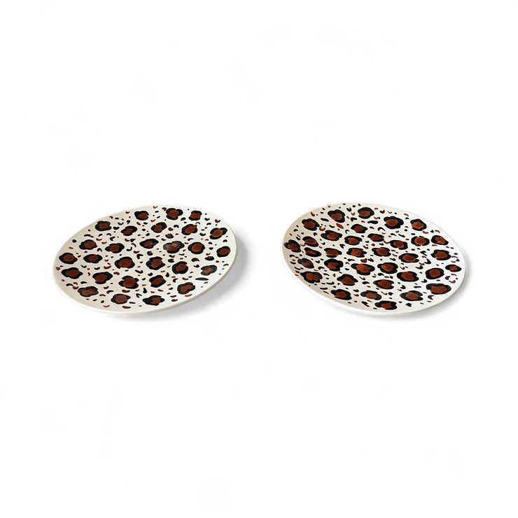 Two ceramic coasters with leopard print pattern on a white background