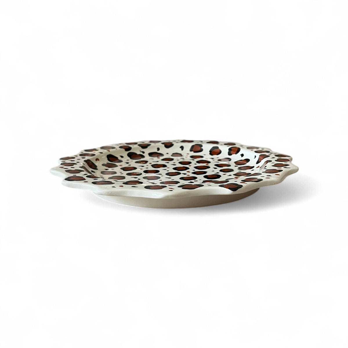 Decorative plate with brown polka dot pattern on a white background