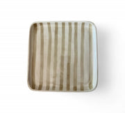 Square ceramic plate with striped pattern on a white background