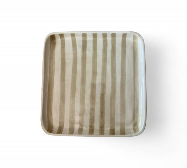 Square ceramic plate with striped pattern on a white background