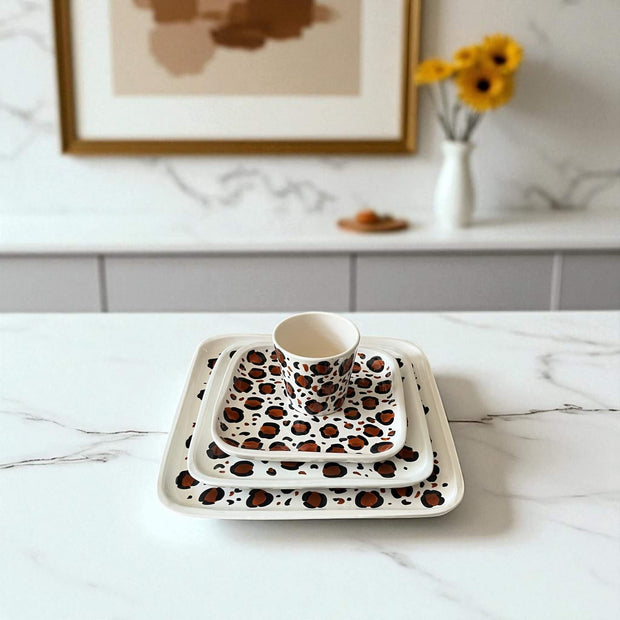 Set of ceramic dishes with leopard print pattern on a marble surface