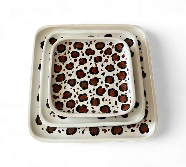 Set of two ceramic trays with leopard print design on a white background