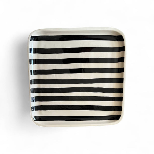 Square ceramic plate with black and white stripes on a white background