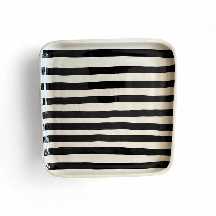 Square ceramic plate with black and white stripes on a white background
