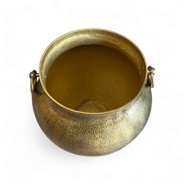 Brass pot with handles on a white background