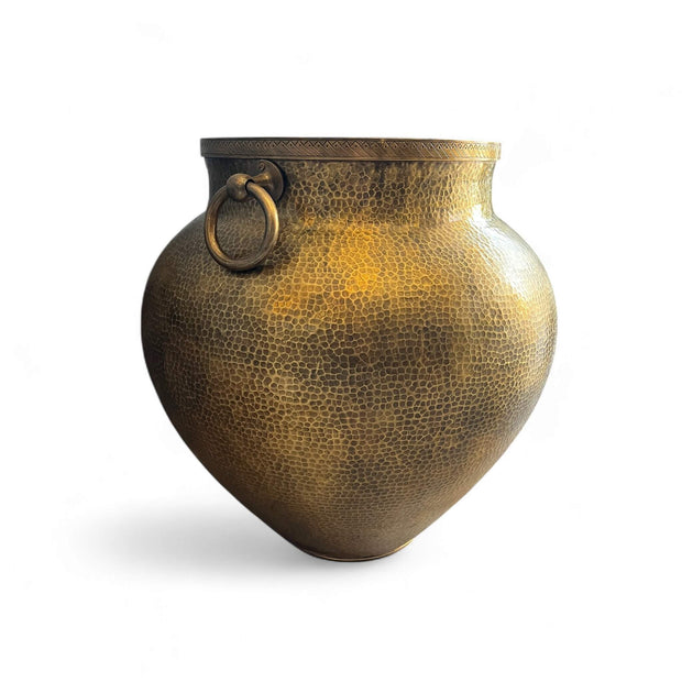 Bronze vase with textured surface and ring handle on a white background