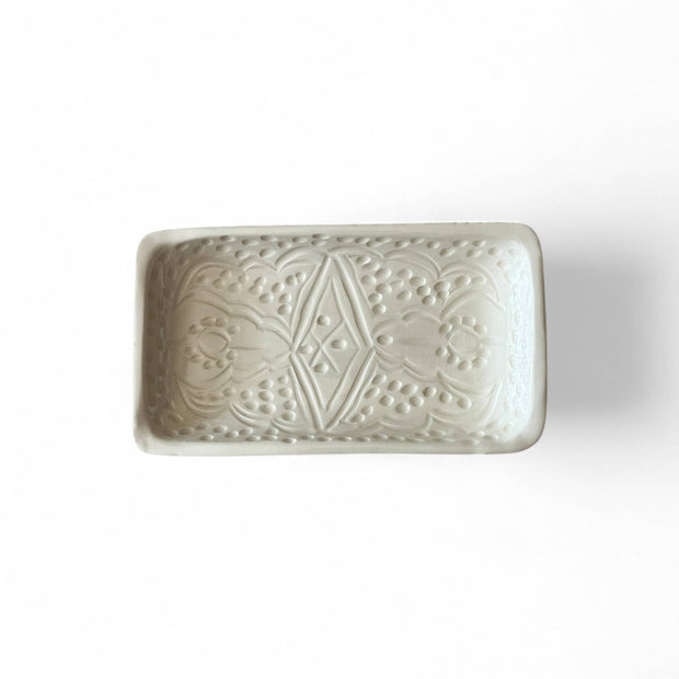 Rectangular ceramic dish with embossed pattern on a white background