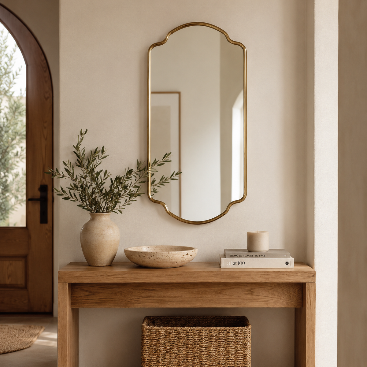 Handmade antique brass arched wall mirror with stepped Moroccan inspired frame.