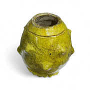 Yellowish-brown ceramic vase on a white background