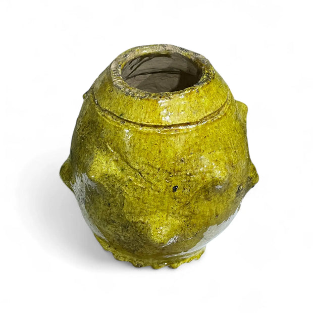 Yellowish-brown ceramic vase on a white background
